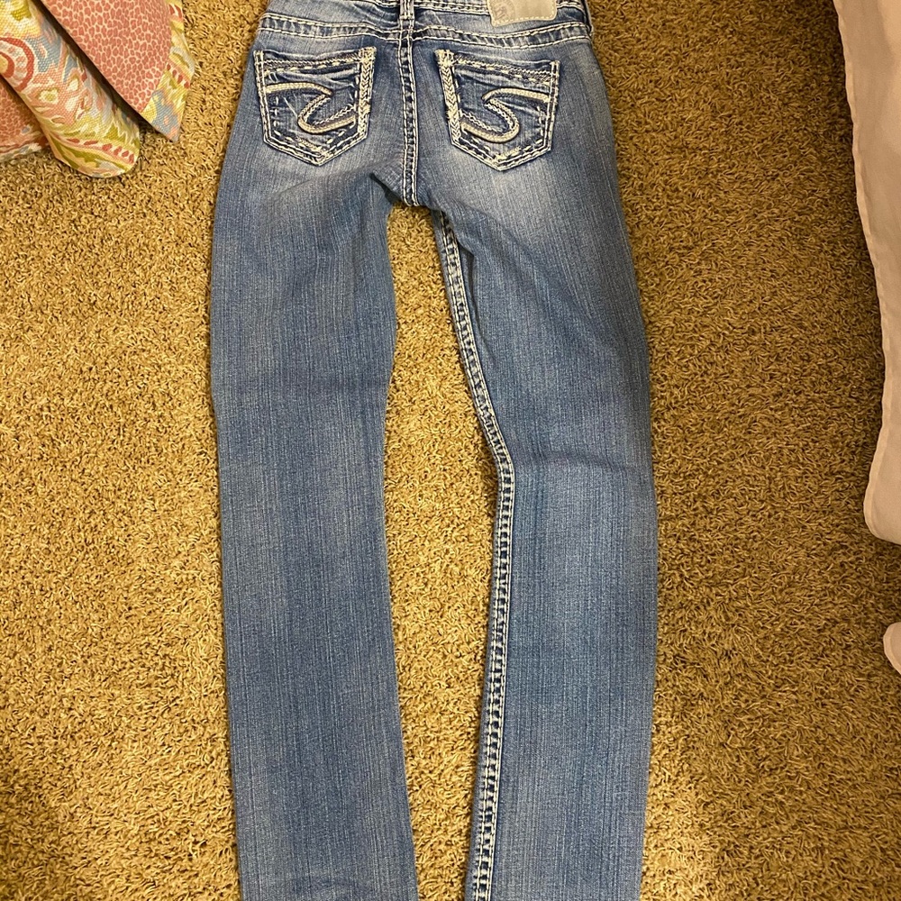 Silver skinny jeans.